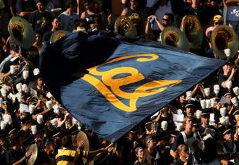 PASADENA, CA - OCTOBER 17:  A California Golden Bears cheerleader waves a flag in front of the Cal band and visitor's section in the game with the UCLA Bruins on October 17, 2009 at the Rose Bowl in Pasadena, California.   Cal won 45-26.  (Photo by Stephen Dunn/Getty Images)