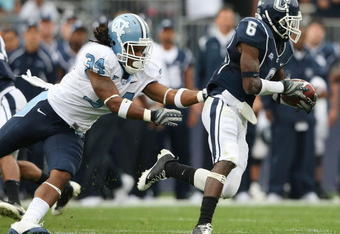 EAST HARTFORD, CT - SEPTEMBER 12:  Jasper Howard #6 of the Connecticut Huskies carries the ball as Johnny White #34 of the North Carolinia Tar Heels tries to make the tackle on September 12, 2009 at Rentschler Field in East Hartford, Connecticut.  (Photo by Elsa/Getty Images)