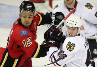 CALGARY, CANADA - APRIL 20: Jarome Iginla #12 of the Calgary Flames and Colin Fraser #46 of the Chicago Blackhawks battle for position during Game Three of the Western Conference Quarterfinals of the 2009 Stanley Cup Playoffs on April 20, 2009 at the Pengrowth Saddledome in Calgary, Alberta, Canada.  (Photo by Mike Ridewood/Getty Images)