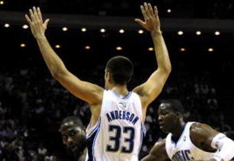 ORLANDO, FL - OCTOBER 28:  Elton Brand #42 of the Philadelphia 76ers looks for an open pass around Ryan Anderson #33 and Mickael Pietrus #20 of the Orlando Magic during the game on October 28, 2009 at Amway Arena in Orlando, Florida.  NOTE TO USER: User expressly acknowledges and agrees that, by downloading and/or using this Photograph, user is consenting to the terms and conditions of the Getty Images License Agreement.  (Photo by Sam Greenwood/Getty Images)