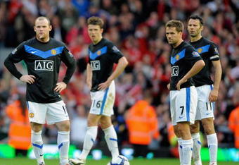 LIVERPOOL, ENGLAND - OCTOBER 25:  Wayne Rooney (L) and Michael Owen of Manchester United prepare to kick off after conceding a second goal during the Barclays Premier League match between Liverpool and Manchester United at Anfield on October 25, 2009 in Liverpool, England.  (Photo by Michael Regan/Getty Images)
