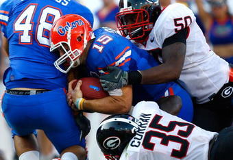 JACKSONVILLE, FL - OCTOBER 31:  Quarterback Tim Tebow #15 of the Florida Gators scores a touchdown against Rennie Curran #35 and Darryl Gamble #50 of the Georgia Bulldogs at Jacksonville Municipal Stadium on October 31, 2009 in Jacksonville, Florida.  (Photo by Kevin C. Cox/Getty Images)