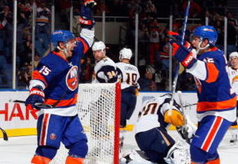 UNIONDALE, NY - OCTOBER 31:  Jeff Tambellini #15 of the New York Islanders celebrates his first goal against the Buffalo Sabres with teammate Josh Bailey #12 on October 31, 2009 at Nassau Coliseum in Uniondale, New York.  (Photo by Jim McIsaac/Getty Images)