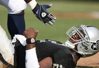 OAKLAND, CA - SEPTEMBER 27:  JaMarcus Russell #2 of the Oakland Raiders is helped up after getting hit against the Denver Broncos on September 27, 2009 during an NFL game at the Oakland-Alameda County Coliseum in Oakland, California.  (Photo by Jed Jacobsohn/Getty Images)