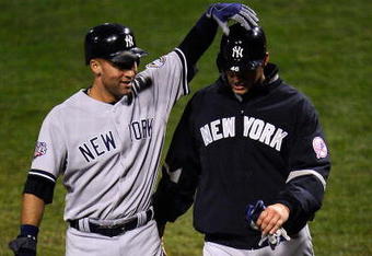 PHILADELPHIA - OCTOBER 31:  Derek Jeter #2 of the New York Yankees celebrates scoring in the fifth inning on a Johnny Damon double with Andy Pettitte #46 against the Philadelphia Phillies in Game Three of the 2009 MLB World Series at Citizens Bank Park on October 31, 2009 in Philadelphia, Pennsylvania.  (Photo by Jeff Zelevansky/Getty Images)
