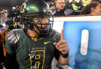 EUGENE, OR - OCTOBER 31: Quarterback Jeremiah Masoli #8 of the Oregon Ducks celebrates with fans on the sidelines as time runs down in the fourth quarter of the game against the USC Trojans at Autzen Stadium on October 31, 2009 in Eugene, Oregon. Masoli threw for 222 yards and a touchdown and ran for 164 more yards with another score as the Ducks upset the Trojans 47-20. (Photo by Steve Dykes/Getty Images)