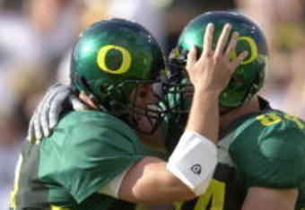 01 Sep 2001: Quarterback Joey Harrington #3 (L) of the Oregon Ducks congratulates teammate Justin Peelle for scoring a touchdown against the Wisconsin Badgers during the Pac-10 game at Autzen Stadium in Eugene, Orgeon.  Oregon won 31-28. DIGITAL IMAGE. Mandatory Credit: Otto Greule/Allsport