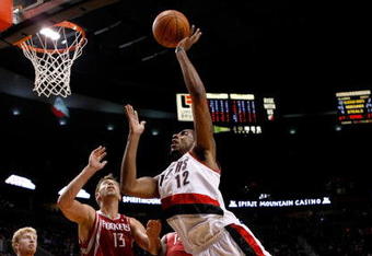 PORTLAND, OR - OCTOBER 27:  LaMarcus Aldridge #12 of the Portland Trail Blazers shoots over Carl Landry #14 of the Houston Rockets during the season opener on October 27, 2009 at the Rose Garden in Portland, Oregon. NOTE TO USER: User expressly acknowledges and agrees that, by downloading and or using this Photograph, user is consenting to the terms and conditions of the Getty Images License Agreement.  (Photo by Jonathan Ferrey/Getty Images)