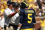 ANN ARBOR, MI - SEPTEMBER 19:  Head coach Rich Rodriguez of the Michigan Wolverines talks with quarterback Tate Forcier #5 during the game with the Eastern Michigan Eagles at Michigan Stadium on September 19, 2009 in Ann Arbor, Michigan.  Michigan won 45-17.  (Photo by Stephen Dunn/Getty Images)