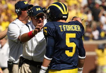 ANN ARBOR, MI - SEPTEMBER 19:  Head coach Rich Rodriguez of the Michigan Wolverines talks with quarterback Tate Forcier #5 during the game with the Eastern Michigan Eagles at Michigan Stadium on September 19, 2009 in Ann Arbor, Michigan.  Michigan won 45-17.  (Photo by Stephen Dunn/Getty Images)