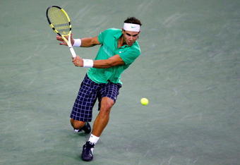 SHANGHAI, CHINA - OCTOBER 18:  Rafael Nadal of Spain returns a shot to Nikolay Davydenko of Russia during the final on day eight of the 2009 Shanghai ATP Masters 1000 at Qi Zhong Tennis Centre on October 18, 2009 in Shanghai, China.  (Photo by Matthew Stockman/Getty Images)