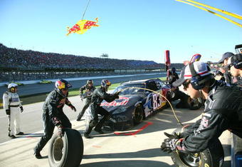 TALLADEGA, AL - NOVEMBER 01:  Brian Vickers, driver of the #83 Red Bull Toyota, makes a pit stop during the NASCAR Sprint Cup Series AMP Energy 500 at Talladega Superspeedway on November 1, 2009 in Talladega, Alabama.  (Photo by Jerry Markland/Getty Images for NASCAR)