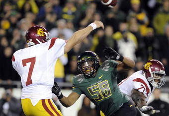 EUGENE, OR - OCTOBER 31: Quarterback Matt Barkley #7 of the USC Trojans gets off a pass as defensive end Will Tukuafu #39 applies pressure in the fourth quarter of the game at Autzen Stadium on October 31, 2009 in Eugene, Oregon. The Ducks upset the Trojans 47-20. (Photo by Steve Dykes/Getty Images)