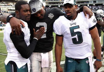 OAKLAND, CA - OCTOBER 18:  Donovan McNabb #5 of the Philadelphia Eagles talks with teammate Michael Vick #7 and JaMarcus Russell #2 of the Oakland Raiders at the end of an NFL game at the Oakland-Alameda County Coliseum on October 18, 2009 in Oakland, California.  (Photo by Jed Jacobsohn/Getty Images)