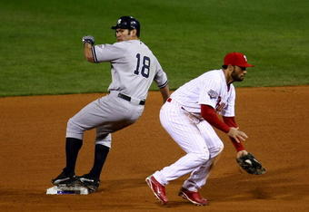 PHILADELPHIA - NOVEMBER 01:  Johnny Damon #18 of the New York Yankees steals second base in the top of the ninth inning against Pedro Feliz #7 of the Philadelphia Phillies in Game Four of the 2009 MLB World Series at Citizens Bank Park on November 1, 2009 in Philadelphia, Pennsylvania. Damon advanced to third on the play. (Photo by Chris McGrath/Getty Images)
