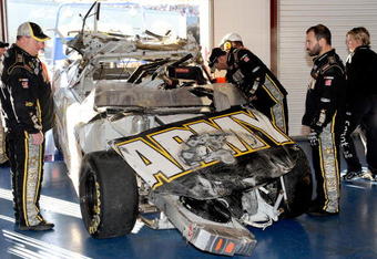 TALLADEGA, AL - NOVEMBER 01:  Crew chief Tony Gibson (L) looks over the #39 U.S Army Chevrolet, driven by Ryan Newman, in the garage after a car incident on track during the NASCAR Sprint Cup Series AMP Energy 500 at Talladega Superspeedway on November 1, 2009 in Talladega, Alabama.  (Photo by Rusty Jarrett/Getty Images for NASCAR)