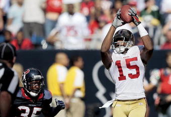 HOUSTON - OCTOBER 25:  Wide receiver Michael Crabtree #15 of the San Francisco 49ers catches a pass in the fourth quarter in front of cornerback Jacque Reeves #35 of the Houston Texans at Reliant Stadium on October 25, 2009 in Houston, Texas.  (Photo by Bob Levey/Getty Images)