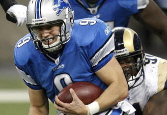 DETROIT , MI - NOVEMBER 01:  Matthew Stafford #9 of the Detroit Lions is tackled by Leonard Little #91 of the St. Louis Rams on November 1, 2009 at Ford Field in Detroit, Michigan.  (Photo by Gregory Shamus/Getty Images)