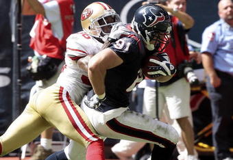 HOUSTON - OCTOBER 25:  Tight end Owen Daniels #81 of the Houston Texans scores as he breaks the tackle of cornerback Shawntae Spencer #36 of the San Francisco 49ers at Reliant Stadium on October 25, 2009 in Houston, Texas.  (Photo by Bob Levey/Getty Images)