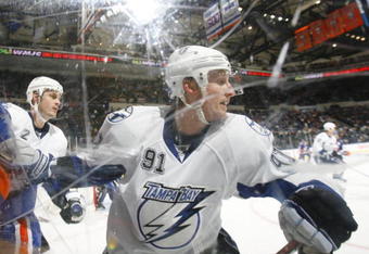 UNIONDALE, NY - APRIL 04: Steven Stamkos #91 of the Tampa Bay Lightning turning away from a check against the New York Islanders in a National Hockey League game at Nassau Coliseum on April 4, 2009 in Uniondale, New York. (Photo by Paul Bereswill/Getty Images)