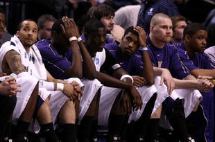 PORTLAND, OR - MARCH 21:  (L) Venoy Overton #1 of the Washington Huskies along with the rest of the Huskies bench react late in the second half before losing to the Purdue Boilermakers during the second round of the NCAA Division I Men's Basketball Tournament at the Rose Garden on March 21, 2009 in Portland, Oregon. The Boilermakers defeated the Huskies 76-74 to advance to the Sweet 16.  (Photo by Jonathan Ferrey/Getty Images)