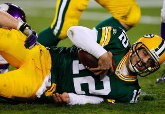 GREEN BAY, WI - NOVEMBER 01:  Quarterback Aaron Rodgers #12 of the Green Bay Packers is sacked during the third quarter of the game against the Minnesota Vikings at Lambeau Field on November 1, 2009 in Green Bay, Wisconsin. (Photo by Scott Boehm/Getty Images)