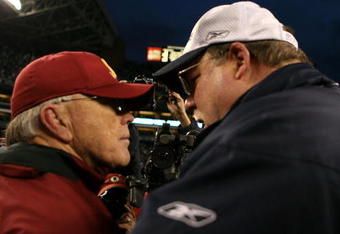 SEATTLE - JANUARY 05:  Head coach Joe Gibbs of the Washington Redskins speaks with head coach Mike Holmgren of the Seattle Seahawks after the Seahawks defeated the Redskins 35-14 after the NFC Wild Card game at Qwest Field on January 5, 2008 in Seattle, Washington.  (Photo by Otto Greule Jr/Getty Images)