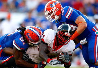 JACKSONVILLE, FL - OCTOBER 31:  Brandon Spikes #51 and Duke Lemmens #44 of the Florida Gators tackle Washaun Ealey #24 of the Georgia Bulldogs at Jacksonville Municipal Stadium on October 31, 2009 in Jacksonville, Florida.  (Photo by Kevin C. Cox/Getty Images)