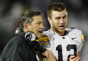 STATE COLLEGE, PA - SEPTEMBER 26:  Head coach Kirk Ferentz of the Iowa Hawkeyes talks with Ricky Stanzi #12 while playing the Penn State Nittnay Lions  on September 26, 2009 at Beaver Stadium in State College, Pennsylvania. Iowa won the game 21-10. (Photo by Gregory Shamus/Getty Images)
