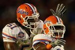 MIAMI - JANUARY 08:  Jermaine Cunningham #21 of the Florida Gators celebrates his interception with teammate Brandon Spikes #51 against the Oklahoma Sooners in the FedEx BCS National Championship Game at Dolphin Stadium on January 8, 2009 in Miami, Florida.  (Photo by Donald Miralle/Getty Images)