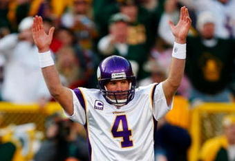 GREEN BAY, WI - NOVEMBER 01: Quarterback Brett Favre #4 of the Minnesota Vikings signals touchdown after teammate Adrian Petersen #20 scored during the first quarter of the game against the Green Bay Packers at Lambeau Field on November 1, 2009 in Green Bay, Wisconsin. (Photo by Scott Boehm/Getty Images)