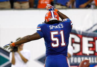 JACKSONVILLE, FL - OCTOBER 31:  Brandon Spikes #51 of the Florida Gators tosses the ball after intercepting a pass for a touchdown against the Georgia Bulldogs at Jacksonville Municipal Stadium on October 31, 2009 in Jacksonville, Florida.  (Photo by Kevin C. Cox/Getty Images)