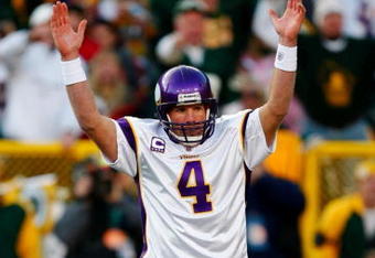 GREEN BAY, WI - NOVEMBER 01: Quarterback Brett Favre #4 of the Minnesota Vikings signals touchdown after teammate Adrian Petersen #20 scored during the first quarter of the game against the Green Bay Packers at Lambeau Field on November 1, 2009 in Green Bay, Wisconsin. (Photo by Scott Boehm/Getty Images)