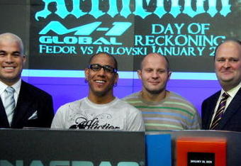 NEW YORK - JANUARY 20:  MMA fighter and former UFC light heavyweight champion Tito Ortiz, VP, Affliction Entertainment Tom Atencio and Fedor Vladimirovich Emelianenko, heavyweight mixed martial artist and current World Alliance of Mixed Martial Arts heavyweight champion rings the NASDAQ opening bell at NASDAQ in Times Square on January 20, 2009 in New York City.  (Photo by Joe Corrigan/Getty Images)
