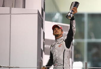 ABU DHABI, UNITED ARAB EMIRATES - NOVEMBER 01:  Jenson Button of Great Britain and Brawn GP celebrates on the podium after finishing third during the Abu Dhabi Formula One Grand Prix at the Yas Marina Circuit on November 1, 2009 in Abu Dhabi, United Arab Emirates.  (Photo by Paul Gilham/Getty Images)