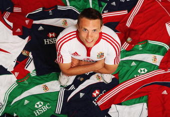 BAGSHOT, ENGLAND - MAY 18:  Mike Blair of Scotland stands among some of the 7,500 pieces of adidas kit that the British & Irish Lions will take to South Africa during the kitting out day for the British & Irish Lions 2009 Tour to South Africa at Pennyhill Park on May 18, 2009 in Bagshot, England. Each member of the best equipped Lions team ever will have at least 80 pieces of personalised adidas training-wear and match-wear in his kitbag.  (Photo by Bryn Lennon/Getty Images for adidas)