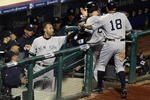 PHILADELPHIA - NOVEMBER 02:  Derek Jeter #2 of the New York Yankees congratulates Mark Teixeira #25 and Johnny Damon #18 as they return to the dugout after they scored on a 2-run double by Alex Rodriguez #13 in the top of the eighth inning against the Philadelphia Phillies in Game Five of the 2009 MLB World Series at Citizens Bank Park on November 2, 2009 in Philadelphia, Pennsylvania.  (Photo by Al Bello/Getty Images)