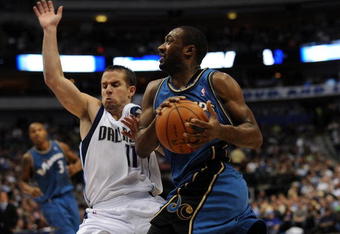 DALLAS - OCTOBER 27:  Guard Gilbert Arenas #0 of the Washington Wizards is fouled by Jose Juan Barea #11 of the Dallas Mavericks during the season opener on October 27, 2009 at American Airlines Center in Dallas, Texas.  NOTE TO USER: User expressly acknowledges and agrees that, by downloading and/or using this Photograph, user is consenting to the terms and conditions of the Getty Images License Agreement.  (Photo by Ronald Martinez/Getty Images)
