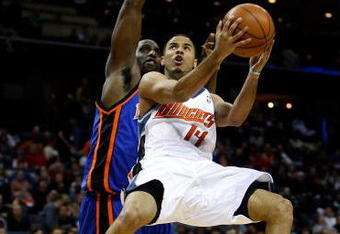 CHARLOTTE, NC - DECEMBER 30:  D.J. Augustin #14 of the Charlotte Bobcats drives to the basket on Malik Rose #31 of the New York Knicks during their game at Time Warner Cable Arena on December 30, 2008 in Charlotte, North Carolina.  (Photo by Streeter Lecka/Getty Images)