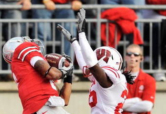 COLUMBUS, OH - OCTOBER 10:  DeVier Posey #8 of the Ohio State Buckeyes pulls in a 32-yard touchdown pass in front of Antonio Fenelus #26 of the Wisconsin Badgers at Ohio Stadium on October 10, 2009 in Columbus, Ohio.  (Photo by Jamie Sabau/Getty Images)