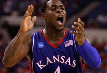 INDIANAPOLIS - MARCH 27:  Sherron Collins #4 of the Kansas Jayhawks reacts in the first half against the Michigan State Spartans during the third round of the NCAA Division I Men's Basketball Tournament at the Lucas Oil Stadium on March 27, 2009 in Indianapolis, Indiana.  (Photo by Andy Lyons/Getty Images)