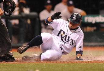ST. PETERSBURG, FL - APRIL 15: Infielder Akinori Iwamura #1 of the Tampa Bay Rays slides into home plate for a run against the New York Yankees at Tropicana Field on April 15, 2009 in St. Petersburg, Florida.  (Photo by Al Messerschmidt/Getty Images)