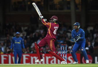 LONDON, ENGLAND - JUNE 19: Chris Gayle of West Indies hits out watched by Kumar Sangakkara of Sri Lanka during the ICC World Twenty20 Semi Final between Sri Lanka and West Indies at the Brit Oval on June 19, 2009 in London, England.  (Photo by Hamish Blair/Getty Images)