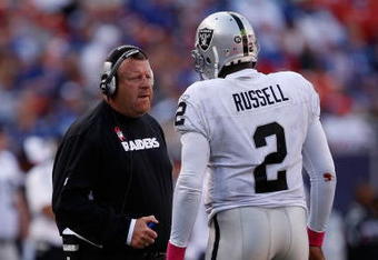 EAST RUTHERFORD, NJ - OCTOBER 11:  Head Coach Tom Cable and JaMarcus Russell #2 of the Oakland Raiders talk in between plays during the game on October 11, 2009 at Giants Stadium in East Rutherford, New Jersey.  (Photo by Jared Wickerham/Getty Images)