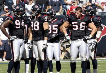 HOUSTON - OCTOBER 25:  Linebacker Brian Cushing #56 of the Houston Texans takes a break along with defensive end Connor Barwin #98 and Antonio Smith #94 during the game against the San Francisco 49ers at Reliant Stadium on October 25, 2009 in Houston, Texas.  (Photo by Bob Levey/Getty Images)
