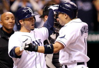ST PETERSBURG, FL - OCTOBER 03:  Akinori Iwamura #1 of the Tampa Bay Rays is congratulated by Jason Bartlett #8 after Iwamura's two run home run in the fifth inning against the Chicago White Sox in Game 2 of the American Leaugue Divisional Series at Tropicana Field on October 3, 2008 in St. Petersburg, Florida.  (Photo by Doug Benc/Getty Images)