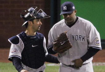 PHILADELPHIA - NOVEMBER 01:  (L-R) Jorge Posada #20 and C.C. Sabathia #52 of the New York Yankees talk against the Philadelphia Phillies in Game Four of the 2009 MLB World Series at Citizens Bank Park on November 1, 2009 in Philadelphia, Pennsylvania.  (Photo by Jed Jacobsohn/Getty Images)