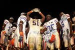 MIAMI - JANUARY 08:  Brandon Spikes #51 of the Florida Gators celebrate with the trophy after defeating the Oklahoma Sooners in the FedEx BCS National Championship Game at Dolphin Stadium on January 8, 2009 in Miami, Florida. The Gators won the game by a score of 24-14.  (Photo by Donald Miralle/Getty Images)