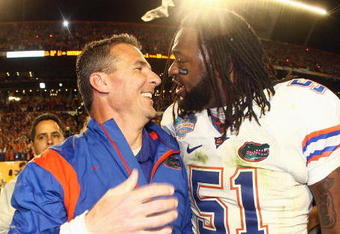 MIAMI - JANUARY 08:  Head coach Urban Meyer of the Florida Gators celebrates with Brandon Spikes #51 their win over the Oklahoma Sooners after the FedEx BCS National Championship Game at Dolphin Stadium on January 8, 2009 in Miami, Florida.  (Photo by Donald Miralle/Getty Images)