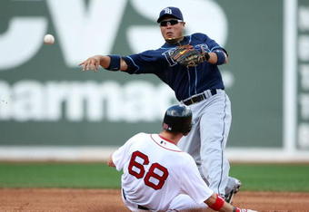BOSTON - SEPTEMBER 13:  Akinori Iwamura #1 of the Tampa Bay Rays sends the ball to first as Josh Reddick #68 of the Boston Red Sox is out at second on September 13, 2009 at Fenway Park in Boston, Massachusetts.  (Photo by Elsa/Getty Images)